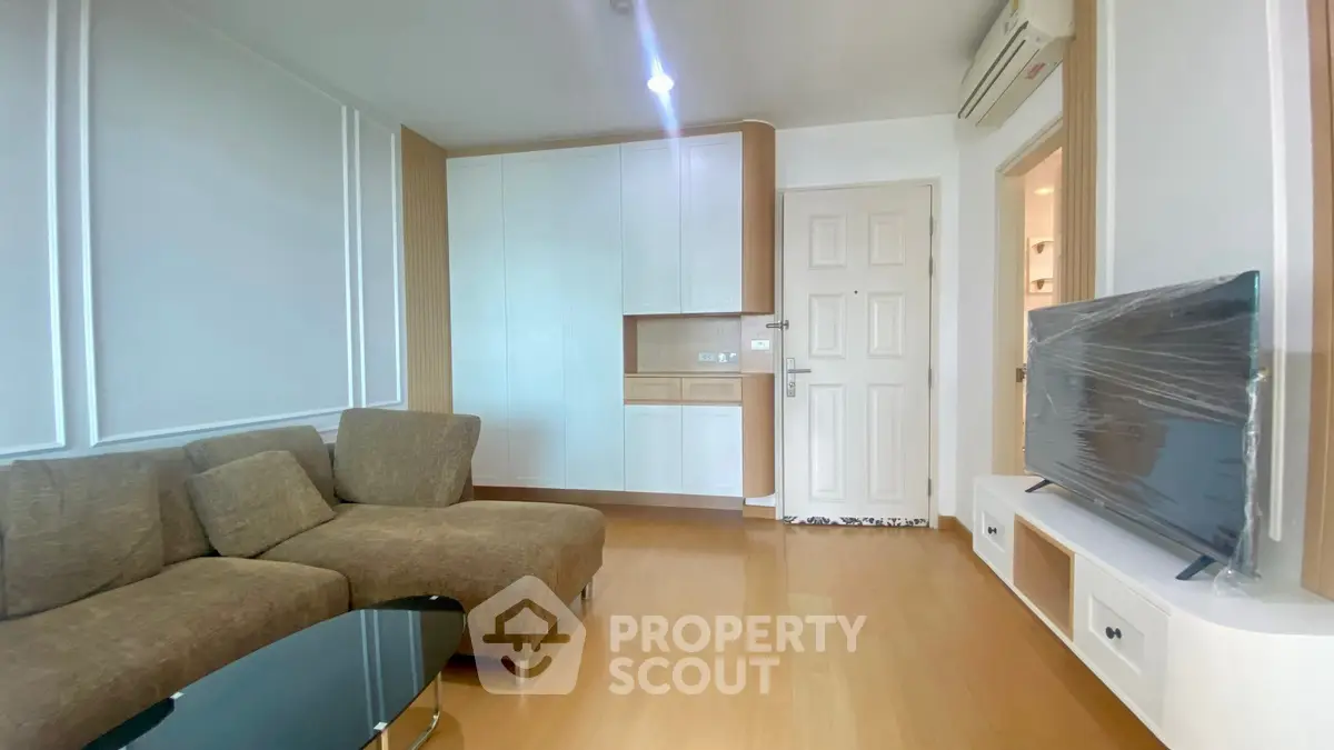 Modern living room with sleek furniture and built-in storage, perfect for urban living.