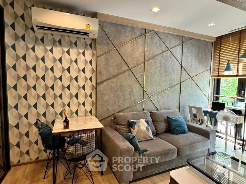 Stylish modern living room with geometric wall design and cozy seating area