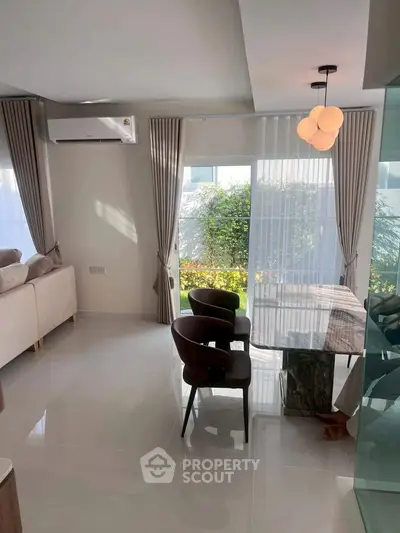 Modern living room with elegant dining area and large windows