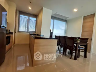 Modern open kitchen and dining area with sleek design and natural light.