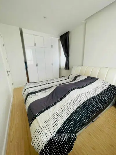 Cozy bedroom with modern decor and ample natural light