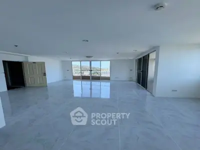 Spacious open-plan living area with large windows offering stunning views, perfect for modern living.