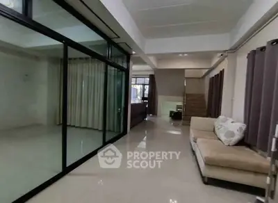 Spacious modern living room with glass partition and elegant decor