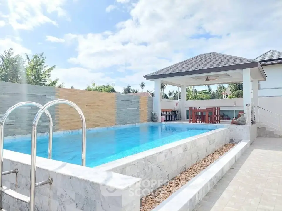 Luxurious outdoor pool area with modern gazebo and elegant stonework, perfect for relaxation and entertainment.