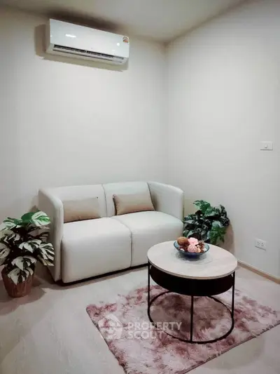 Cozy living room with modern sofa, air conditioning, and stylish decor