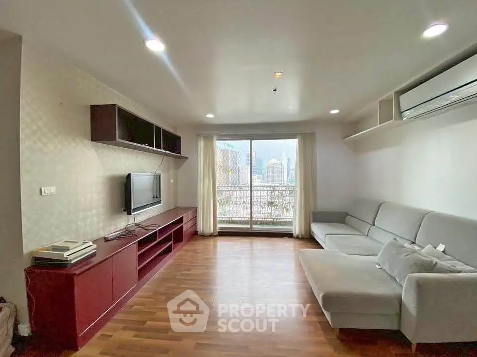 Spacious living room with modern decor and city view balcony