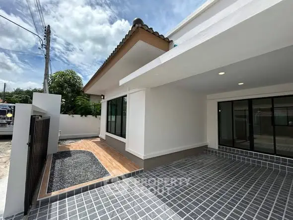 Modern single-story home with spacious driveway and sleek exterior design.