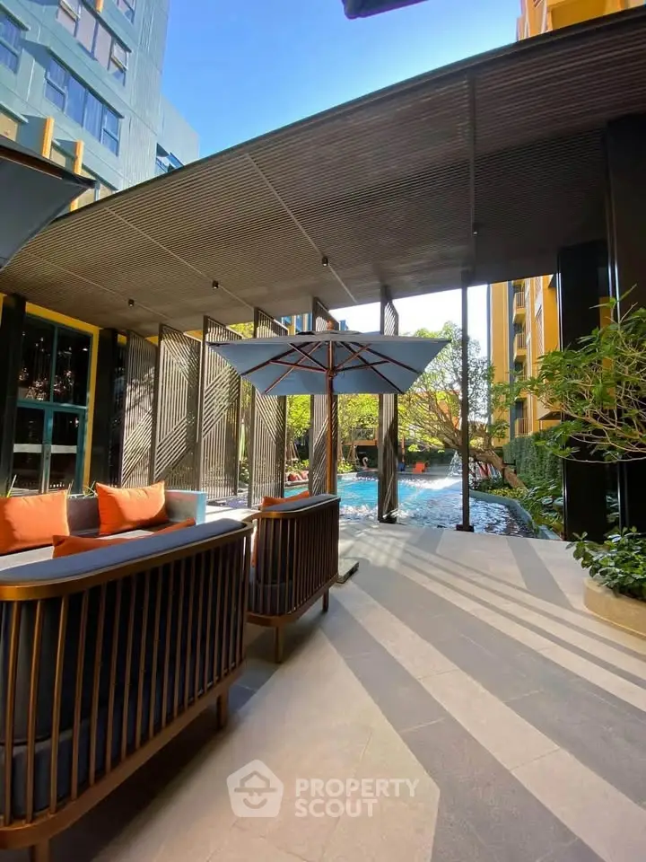 Luxurious outdoor pool area with stylish seating and modern architecture, perfect for relaxation and leisure.