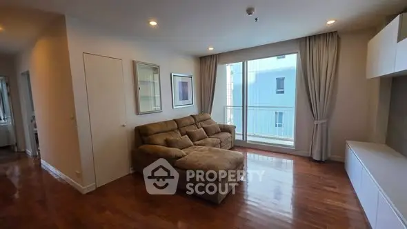 Spacious living room with cozy sectional sofa and large window view.