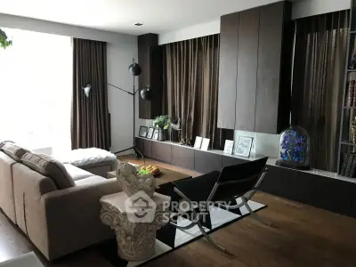 Elegant living room with modern furniture and stylish decor, featuring a cozy seating area and natural light.
