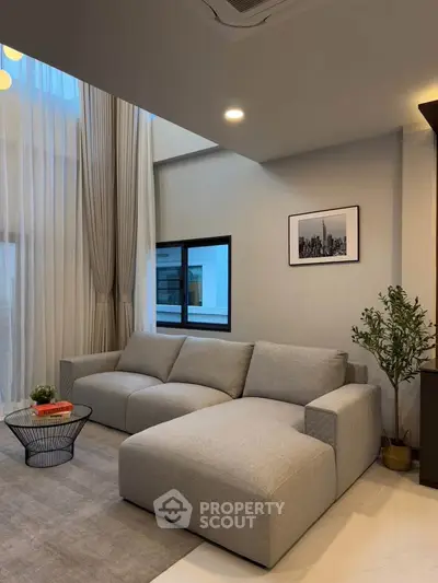 Modern living room with high ceilings and elegant decor