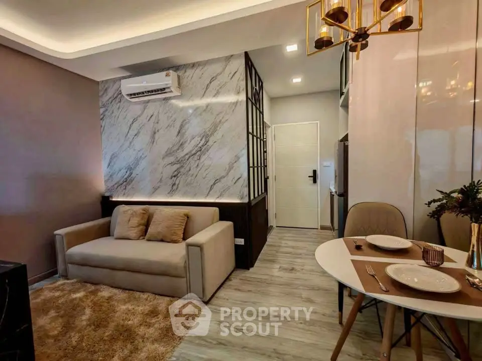 Modern living room with elegant decor and dining area in a stylish apartment.