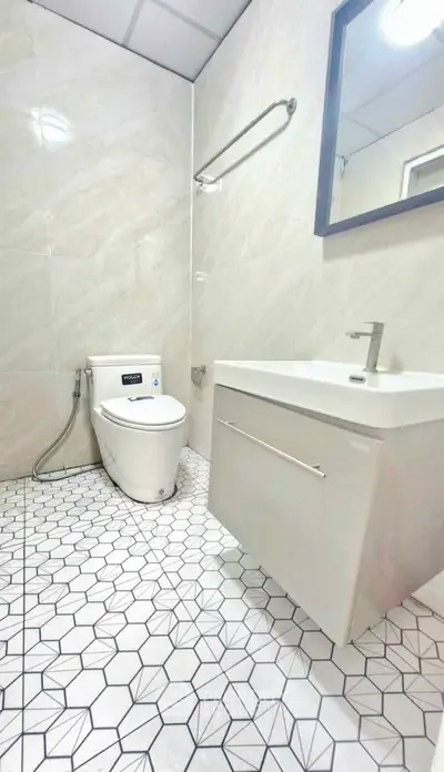 Modern bathroom with sleek fixtures and geometric tile flooring