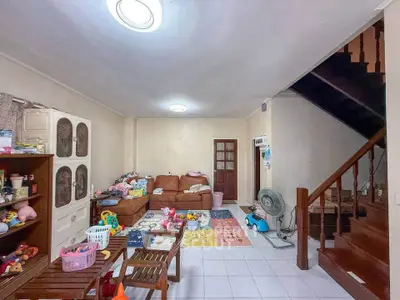 Cozy living room with staircase, ideal for family gatherings and relaxation.