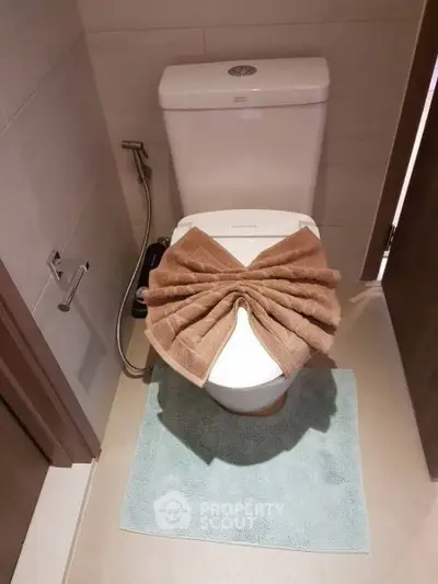 Elegant bathroom with modern toilet and stylish towel arrangement