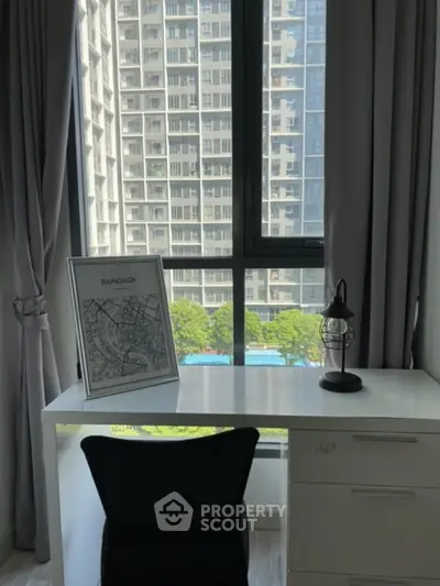 Modern study area with city view, featuring a sleek desk and stylish decor.