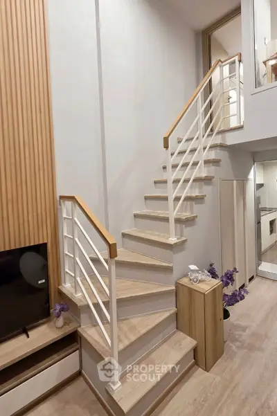 Modern duplex interior with stylish staircase and wooden accents