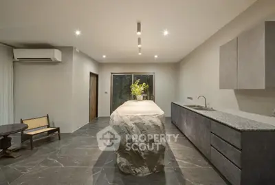 Modern kitchen with unique stone island and sleek cabinetry