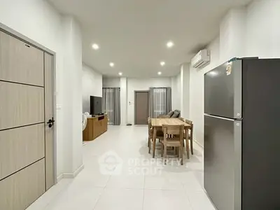 Spacious modern living room with dining area and sleek kitchen appliances