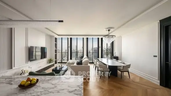 Luxurious open-plan living room with stunning city view and elegant dining area.