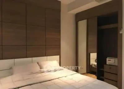 Modern bedroom with wooden accents and mirrored wardrobe
