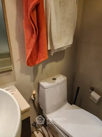 Compact bathroom with modern fixtures and neutral tones