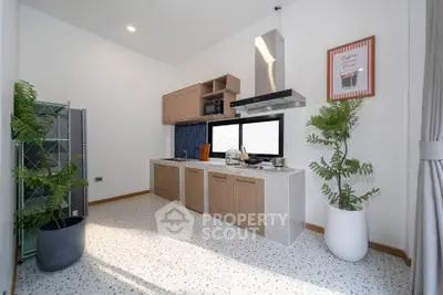 Modern kitchen with sleek cabinetry and stylish decor, featuring open layout and natural light.