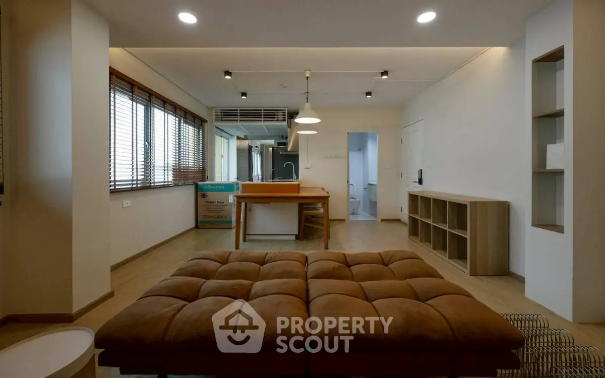 Spacious open-plan living room with modern kitchen and stylish furnishings