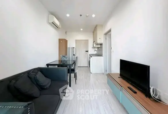 Modern living room with sleek furniture and open kitchen layout