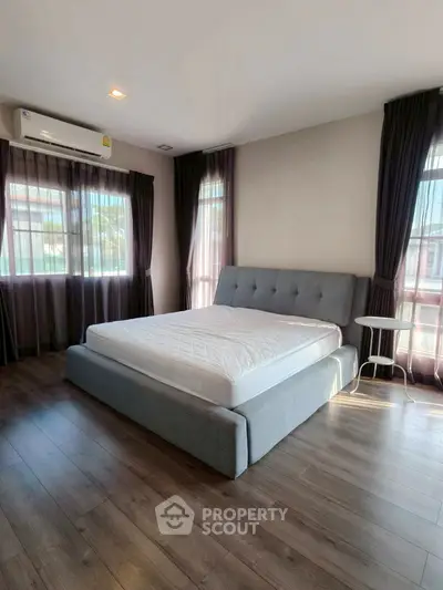 Spacious bedroom with modern design and large windows for natural light