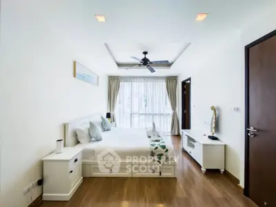Spacious bedroom with modern decor and natural light