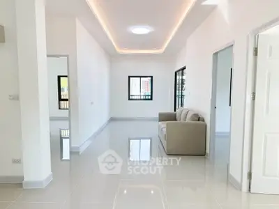 Spacious modern living room with sleek tile flooring and cozy sofa