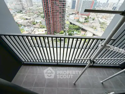 High-rise balcony with stunning cityscape view and modern railing design.