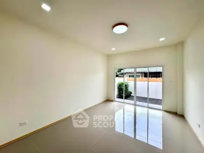 Spacious modern living room with large windows and glossy tiled floor