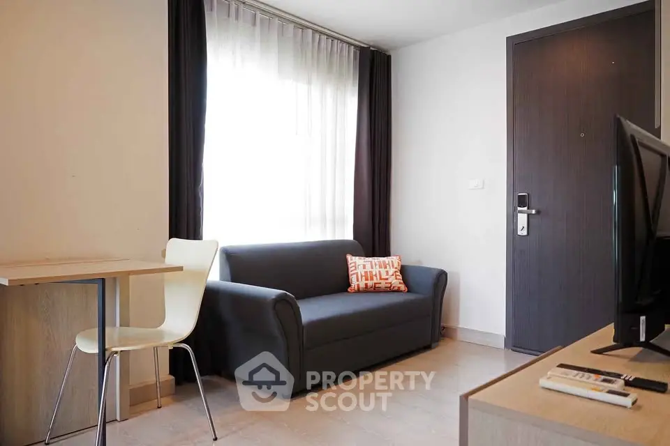 Modern living room with sleek furniture and natural light, perfect for urban living.