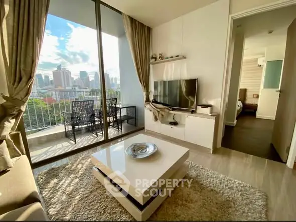 Modern living room with city view and balcony access in a stylish apartment.