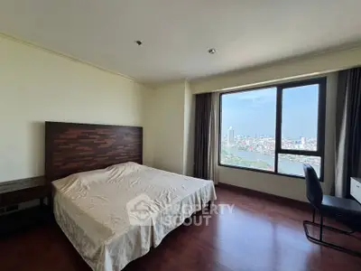 Spacious bedroom with stunning city view and elegant wooden flooring.