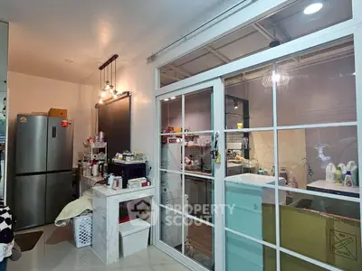 Modern kitchen with sliding glass doors and stainless steel fridge