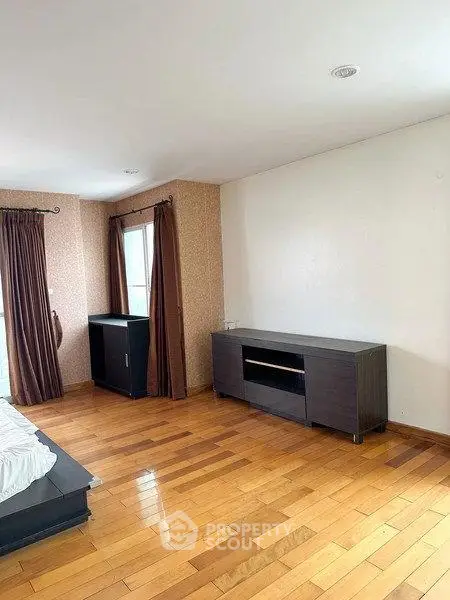 Spacious living room with wooden flooring and modern furniture