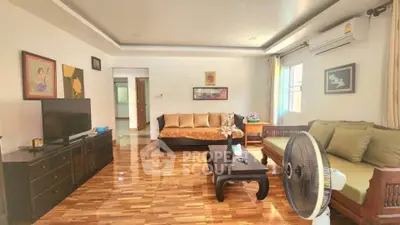 Spacious living room with elegant wooden flooring and stylish furniture