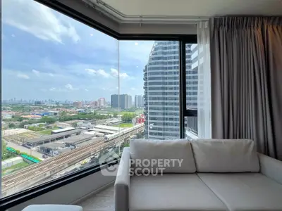 Modern living room with panoramic city view from large corner window.