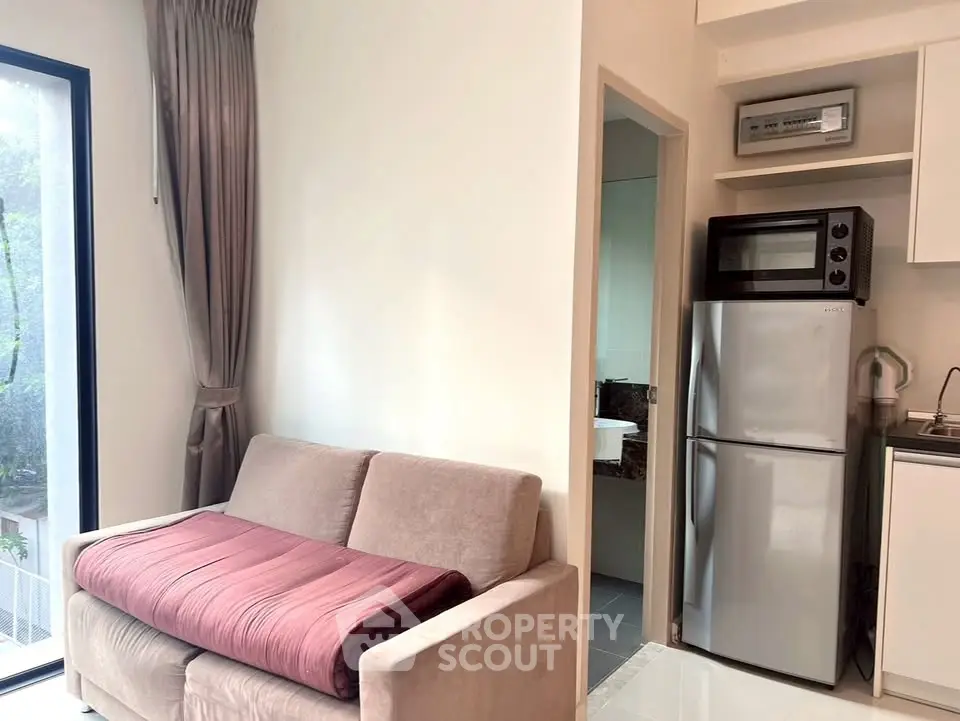 Cozy apartment interior with modern kitchen and comfortable living area, perfect for urban living.