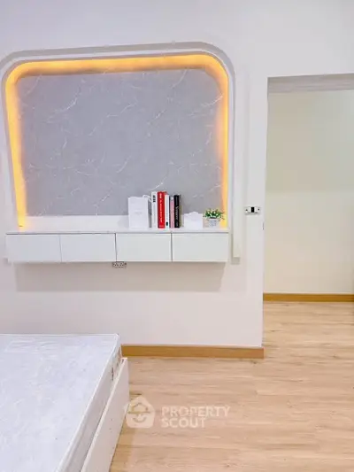Modern bedroom with stylish wall design and built-in storage