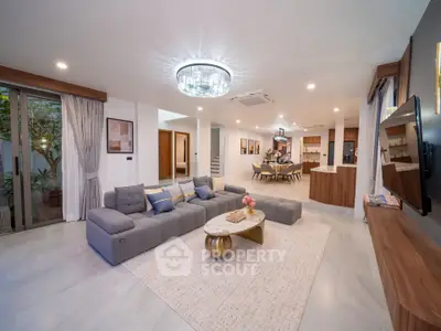 Luxurious open-plan living room with modern decor and elegant lighting