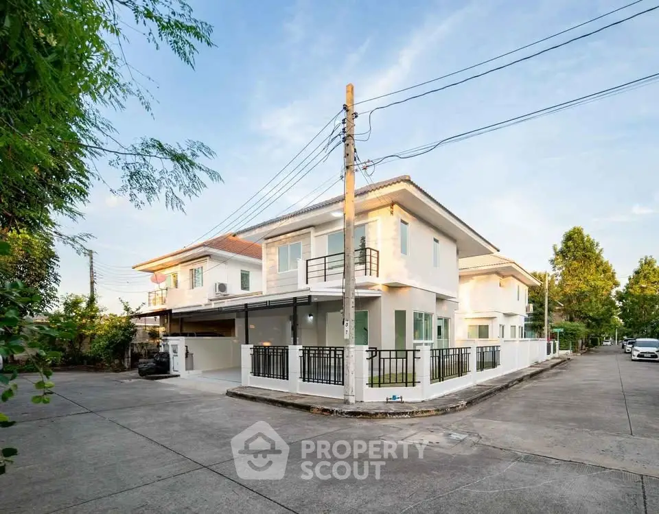 Modern corner unit house with spacious driveway and lush greenery in a serene neighborhood.
