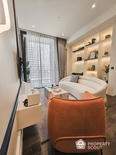 Elegant living room with modern furnishings, built-in shelves, and ample natural light from floor-to-ceiling windows draped with sheer curtains.