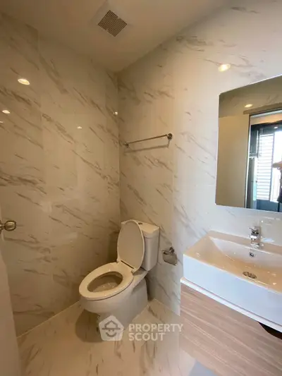 Modern bathroom with elegant marble tiles and sleek fixtures