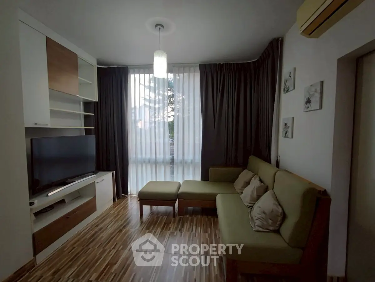 Cozy living room with modern furniture and large window view.