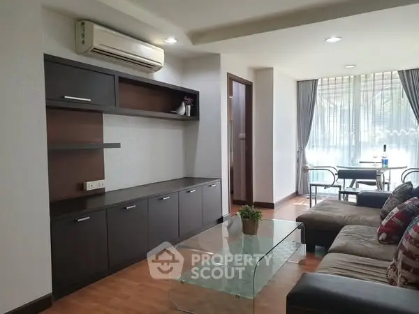 Spacious living room with modern furniture and large windows for natural light.