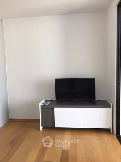 Modern living room with sleek TV stand and wooden flooring